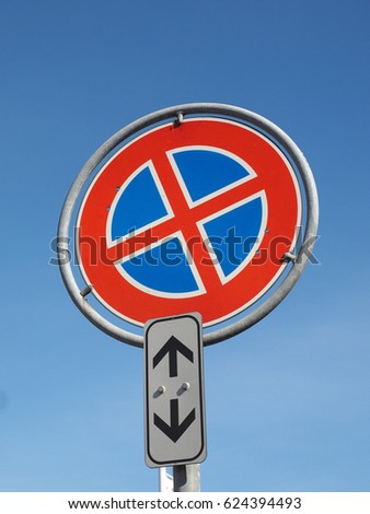 no parking and no stopping traffic sign over blue sky