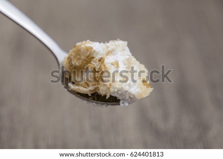 Cream cake in a tea spoon