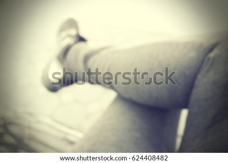 Picture blurred  for background abstract and can be illustration to article of sit with one's legs crossed