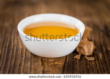 Caramel Sirup on a vintage background as detailed close-up shot (selective focus)