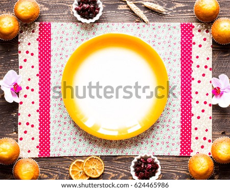 Delicious homemade muffins with yogurt, on a wooden background with space for text. Top view