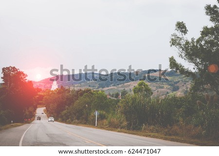 Country road winding through the Phuruea, Thailand.