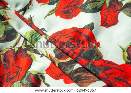 Texture, background, pattern. Cloth Silk Abstract Pattern. On the fabric are painted roses. Red roses on a white background