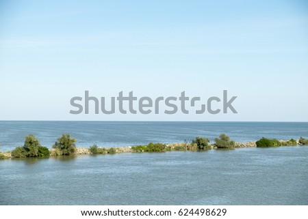 Landscape with the water channel between Danube Delta and Black Sea, Romania, in a summer sunny day