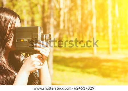 Woman with vintage video camera outdoor