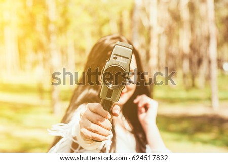 Woman with vintage video camera outdoor