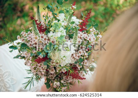 Bohemian bride showing off her beautiful boho flower bouquet. Elegant woman with stylish crown of flowers.
Perfect image for: wedding, florist, magazine, website, fashion, flower decoration subjects.