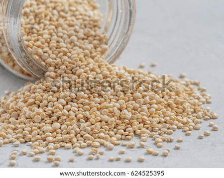 Grain of quinoa. Uncooked raw quinoa in bank on gray background. Healthy vegan food concept and pattern.