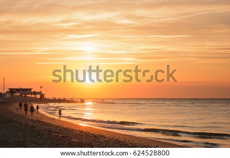 Beautiful warm beach sunset with ocean and waves