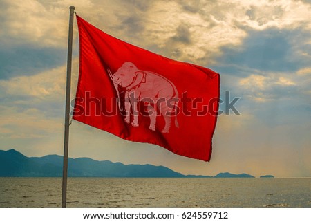 Flag symbol of white elephant on red cloth.
