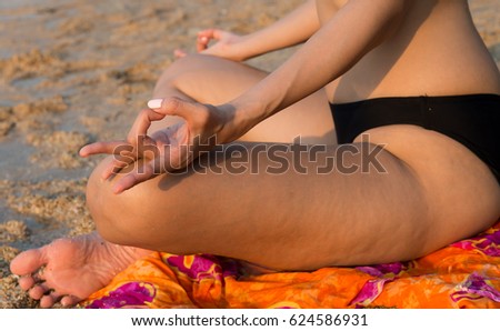 Yoga concept. hand bikini woman practicing lotus pose on the beach,Healthy female in peace,Soul and mind zen balance concept,Toned picture, Meditation - woman on beach meditating by ocean sea serene 