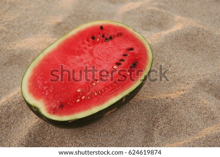 Travel to Koh Lanta, Thailand. A watermelon on the sandy beach on the sunset.