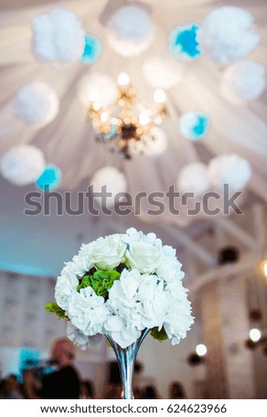 beautiful bouquet of white flowers stand on a table