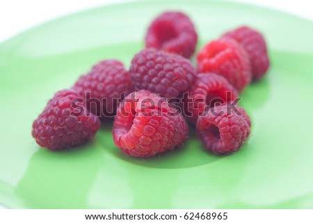 raspberries lying on a green plate