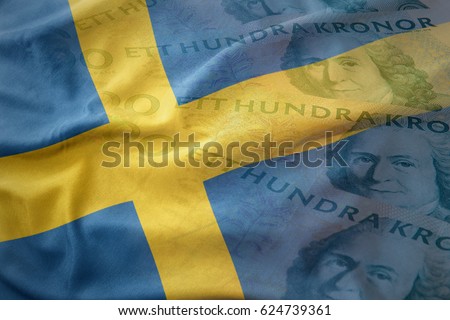 colorful waving national flag of sweden on a swedish crown money banknotes background. finance concept Royalty-Free Stock Photo #624739361