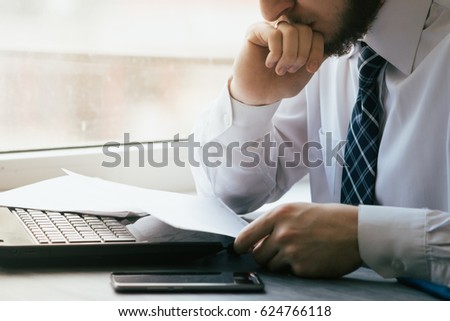 Young businessman sitting behind crumpled paper expectations Emotion Royalty-Free Stock Photo #624766118