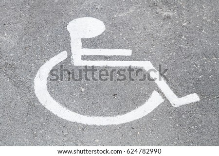 Disabled person sign painted on the asphalt