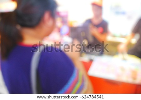 Picture blurred  for background abstract and can be illustration to article of Woman use smartphone shopping at shop