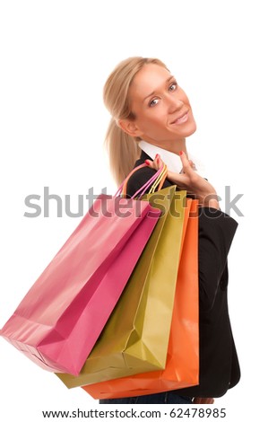Beautiful young businesswoman holding  shopping bags. Isolated on white