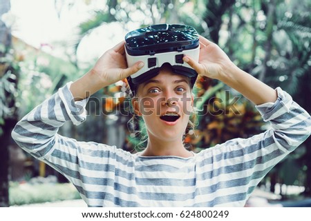 Attractive woman wearing virtual reality goggles. VR headset. Unusual double exposure virtual reality concept.