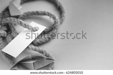 white sticker with thick braided rope and ship paper origami