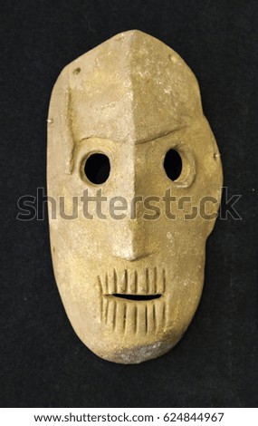 Old stone mask of fear, symbol and history