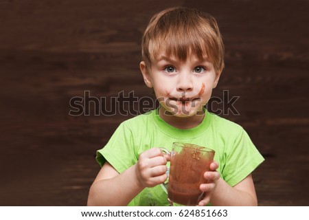 the kid drinking cocoa at home.