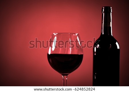 Wine bottles with grapes and cheese on wooden rustic background. copy space