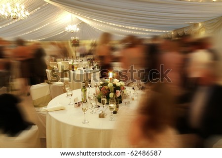 many people at a wedding reception in a marquee Royalty-Free Stock Photo #62486587