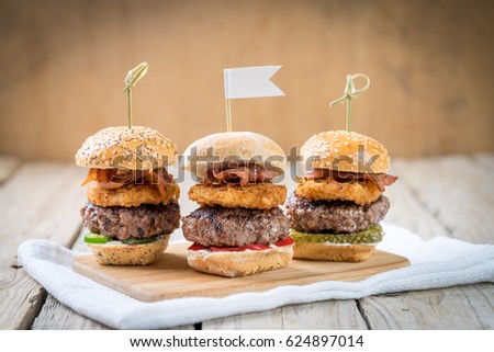 Small beef sliders grilled burgers onion rings little buns bacon served as appetisers for sharing   Royalty-Free Stock Photo #624897014