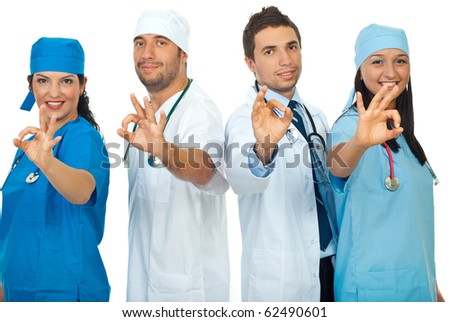 Successful team of doctors showing okay sign hand and standing in a row  isolated on white background