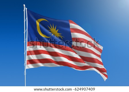 The National flag of Malaysia blowing in the wind in front of a clear blue sky