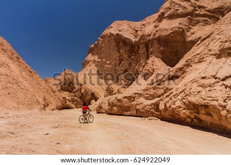 Atacama Desert - Chile, considered the driest and most arid in the world. 
Among its beautiful and large rocks, women explore the desert by bicycle