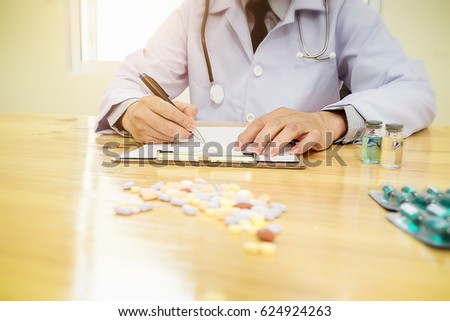 medicine doctor  working in hospital or pharmacist sitting at worktable, writing prescription on special form.Medical care and medical,Stethoscope with clipboard,pharmacy or insurance concept