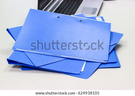file folder with documents and Notebook background  on white table