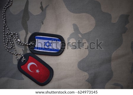 army blank, dog tag with flag of israel and turkey on the khaki texture background. military concept