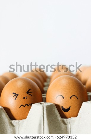 Eggs With Cartoon Emotional Faces in Egg Tray