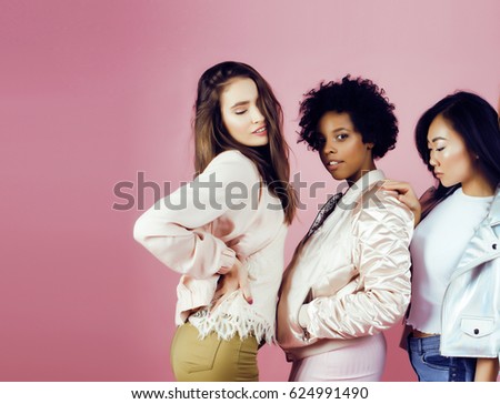 different nation girls with diversuty in skin, hair. Asian, scandinavian, african american cheerful emotional posing on pink background, woman day celebration, lifestyle people concept 