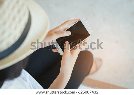 Cropped image of woman's hands holding smart phone with blank copy space screen for your text message