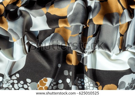 Texture, background, pattern. Abstract pattern on a silk fabric, white yellow brown circles