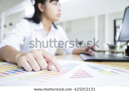 Graphic designer using graphics tablet and computer in the office, with soft focus, vintage tone