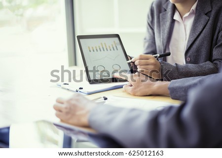 Business people analyzing investment charts with teblet in meeting room, Accounting concept, soft focus, vintage tone Royalty-Free Stock Photo #625012163