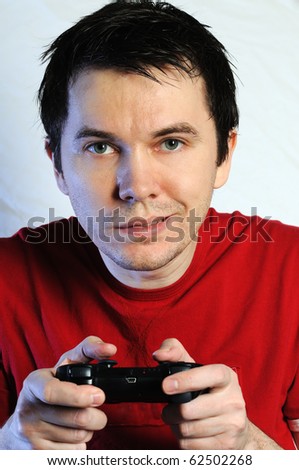 Man with game pad playing video-game. White background.
