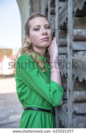 Blonde girl in lace dress in an old fortress