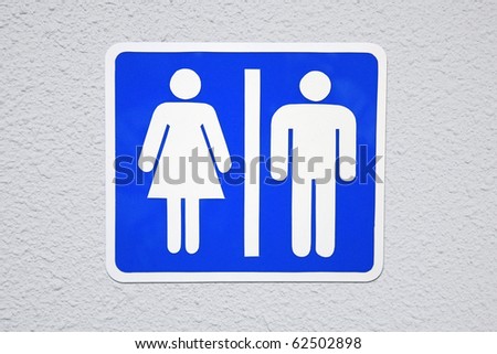 Toilet Sign on white wall background.