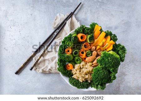 Health care, diet and nutrition concept. Buddha bowl with chopsticks on a rustic table, vegetarian vegan raw balanced detox meal food. Top view flat lay overhead