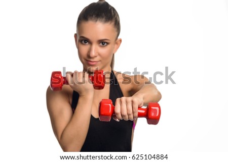 Sporty girl using dumbbells. Arms bending and straightening alternately holding weights to give strength to muscles. Isolated on white, selective focus.
