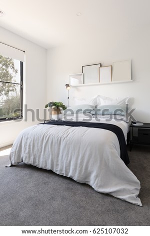 Gorgeous bedroom with luxury linen and a pot plant