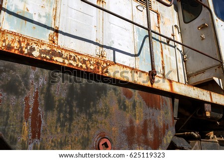Old rusty train locomotive thrown into exclusion zone of Chernobyl. Zone of high radioactivity. Ghost town of Pripyat. Chernobyl disaster. Rusty abandoned Soviet machinery in area of nuclear accident 