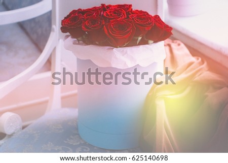 Soft focus picture of blue box of red roses
